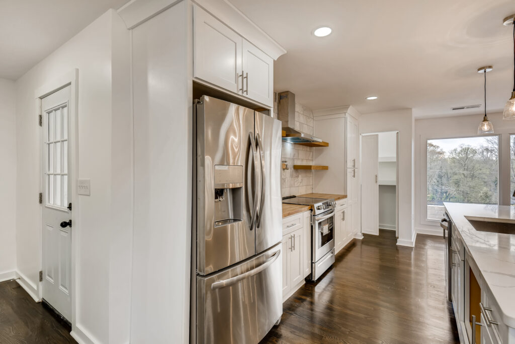 Kitchen renovation with white cabinetry and stainless steel appliances - Parsons Mission Construction Atlanta metro