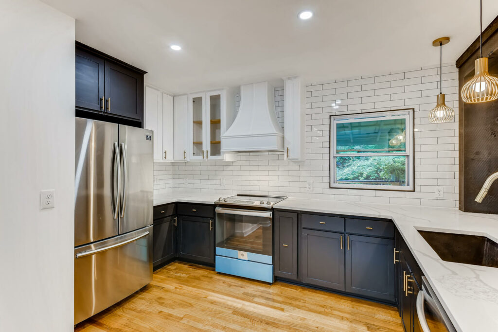 Kitchen remodeling Atlanta GA - white cabinetry, quartz countertops, and stainless steel appliances | Parsons Mission Construction